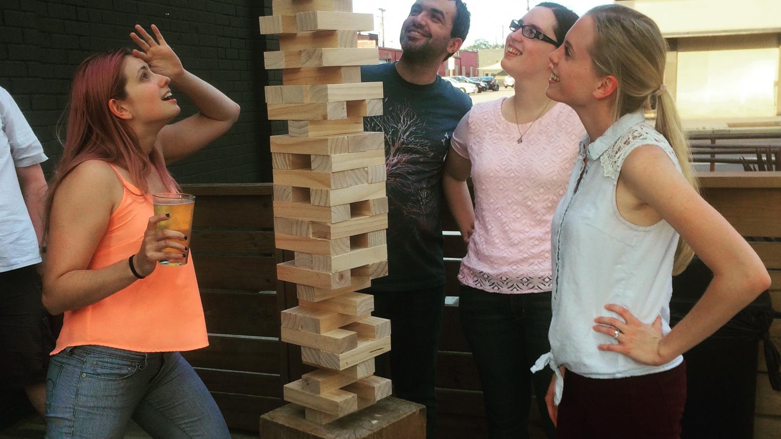 NGP students play Jenga at a happy hour event