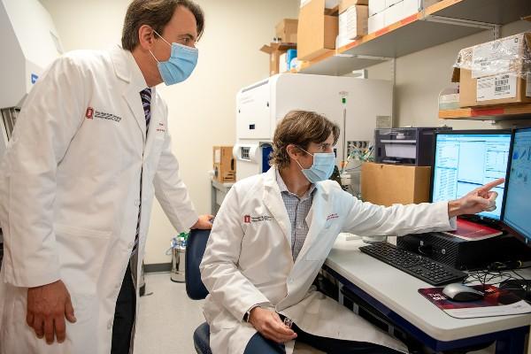 Dr. Benjamin Segal (left) and Dr. Andrew Sas examine the properties of a newly-discovered cell in a lab at The Ohio State University Wexner Medical Center. This immune cell has the potential to treat neurological conditions long believed to be incurable, including multiple sclerosis, ALS and spinal cord injuries.